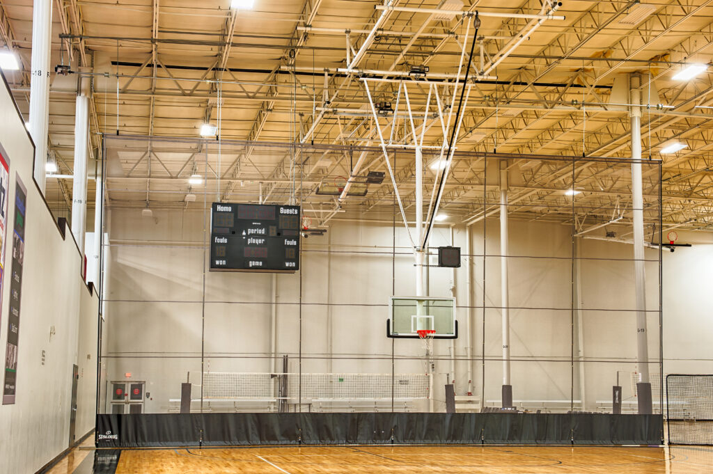 Gymnasium with Spalding Basketball Hoops, Volleyball Systems, and Divider Curtain